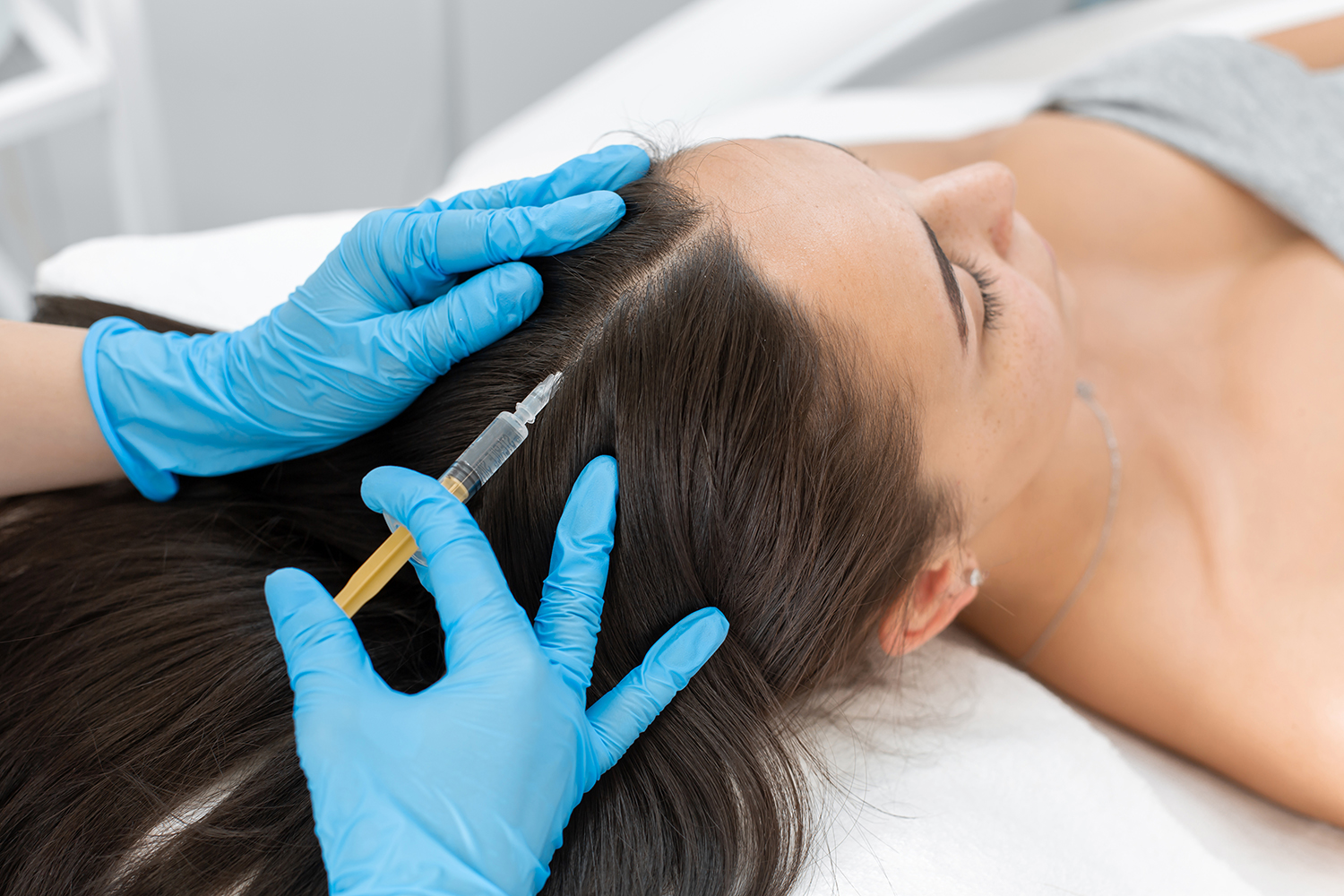 Beautician injections for healthy hair growth. Mesotherapy of the scalp. A young girl is undergoing a course of spa treatments in the office of a beautician. Moisturizing, cleaning and facial skin care. Cosmetic procedures.